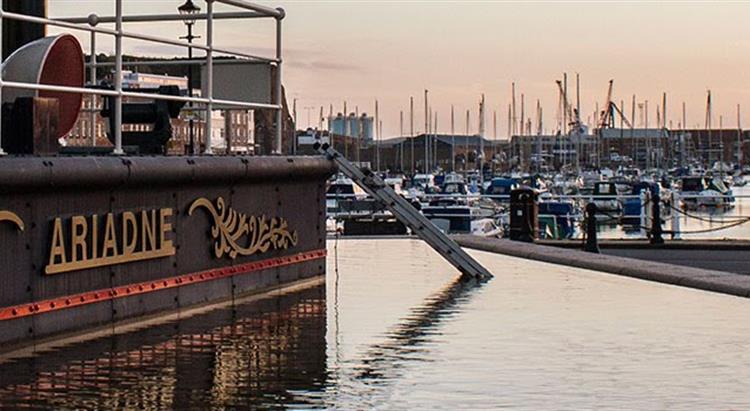 Photo of Jersey steam clock at sunset with view of harbour